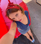 Millie Bobby Brown wears red knitted crop top and trousers