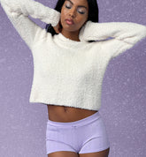 Millie Bobby Brown wears red knitted crop top and trousers